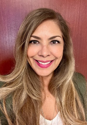 A person smiling at the cameraDescription automatically generated